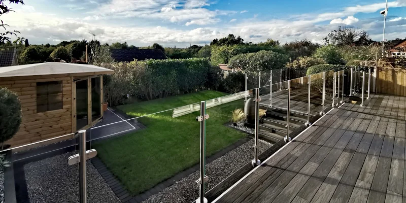 Glass and stainless steel balustrade overlooking a garden