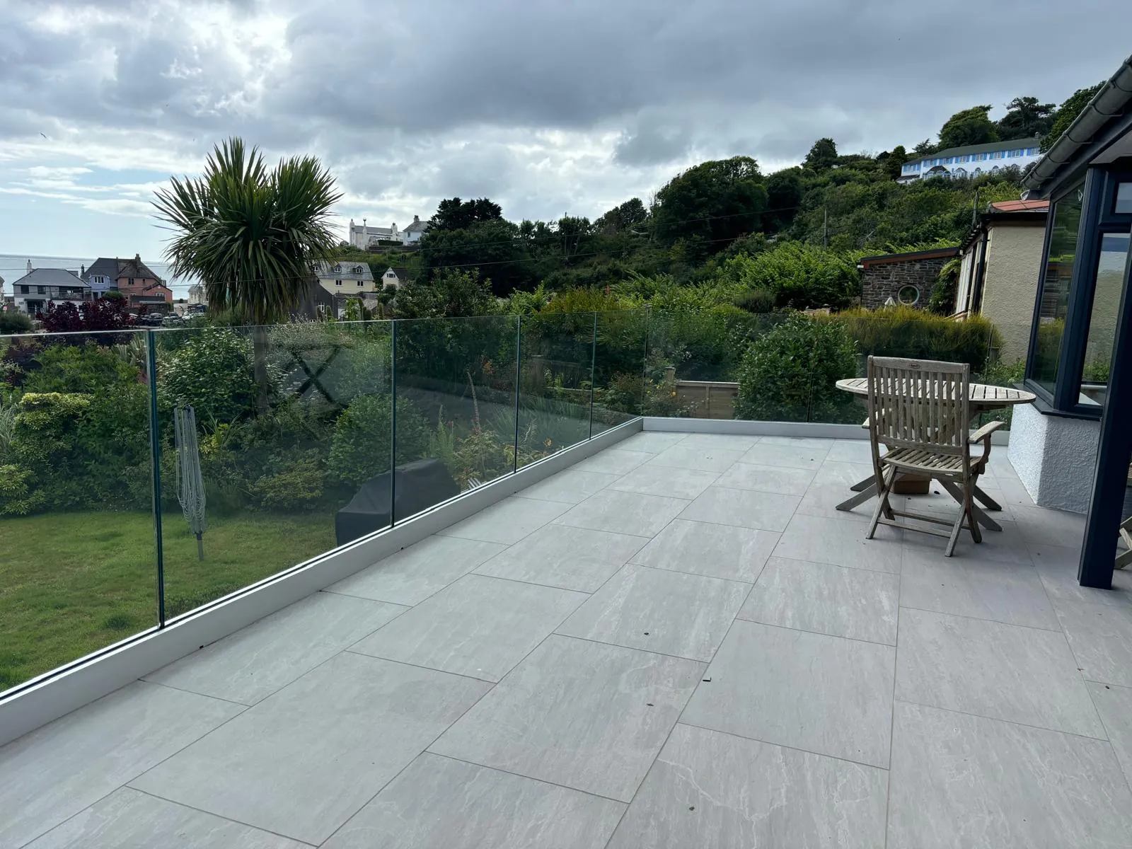 Modern glass balustrade beside a garden