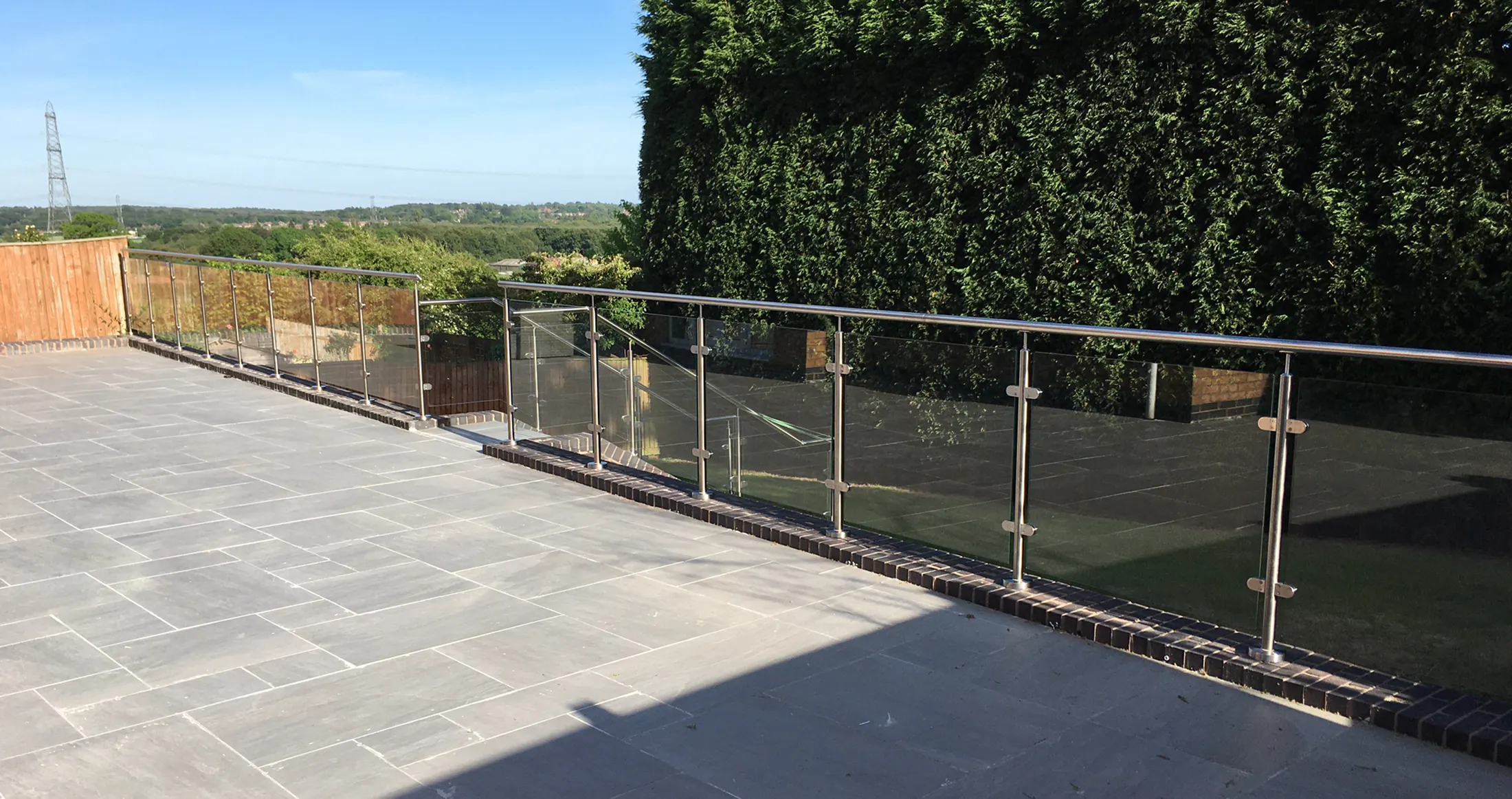 Executive stainless-steel and glass balustrade overlooking the coast